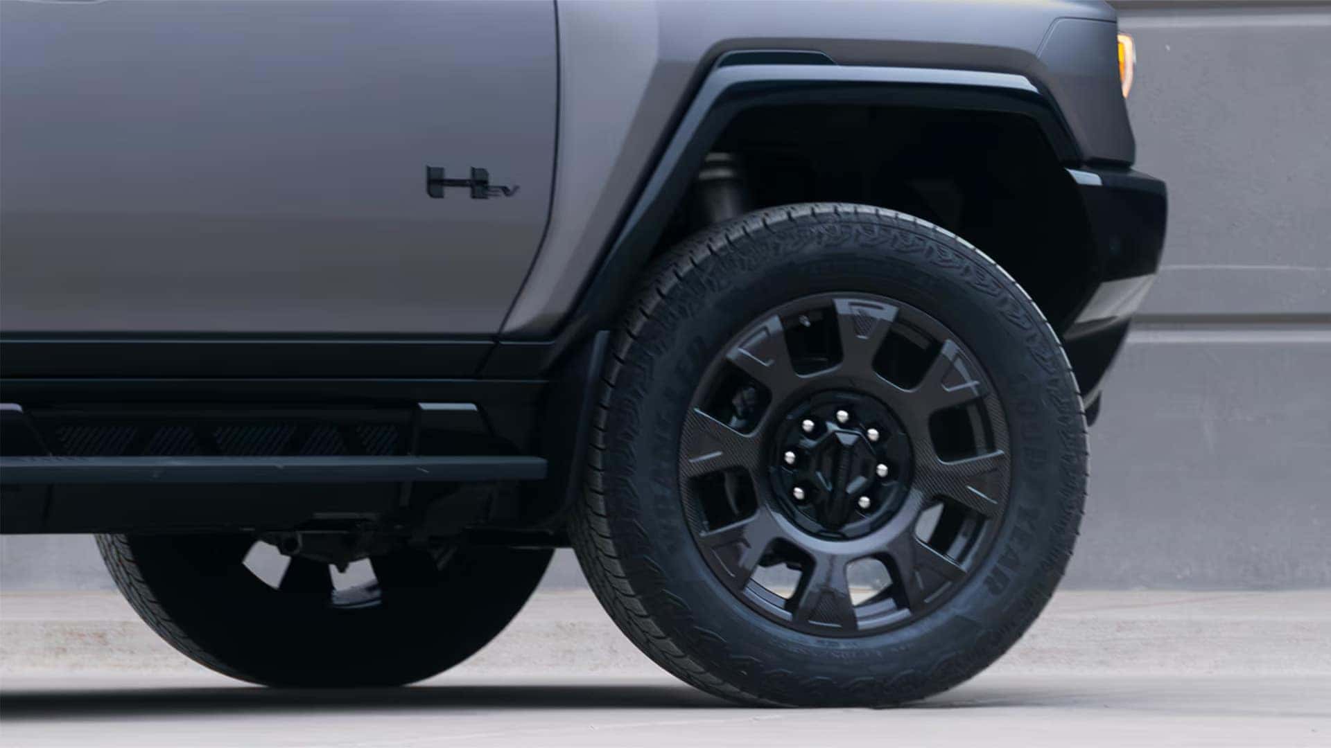 Close-up of 2026 GMC HUMMER EV SUV wheel and tire showing rugged design and large alloy wheel styling