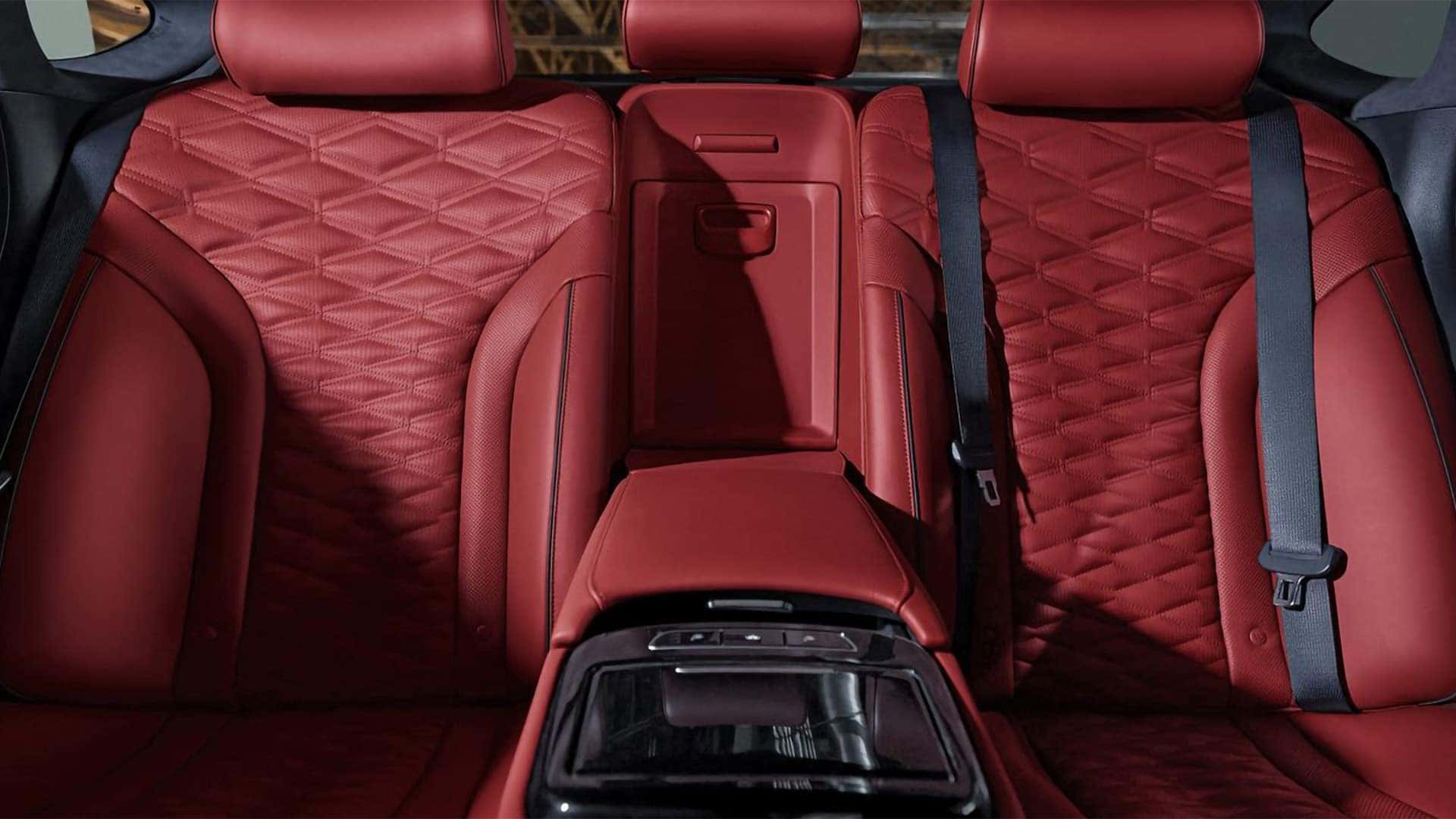 2026 Genesis G80 rear seats with red quilted Nappa leather and fold-down center armrest