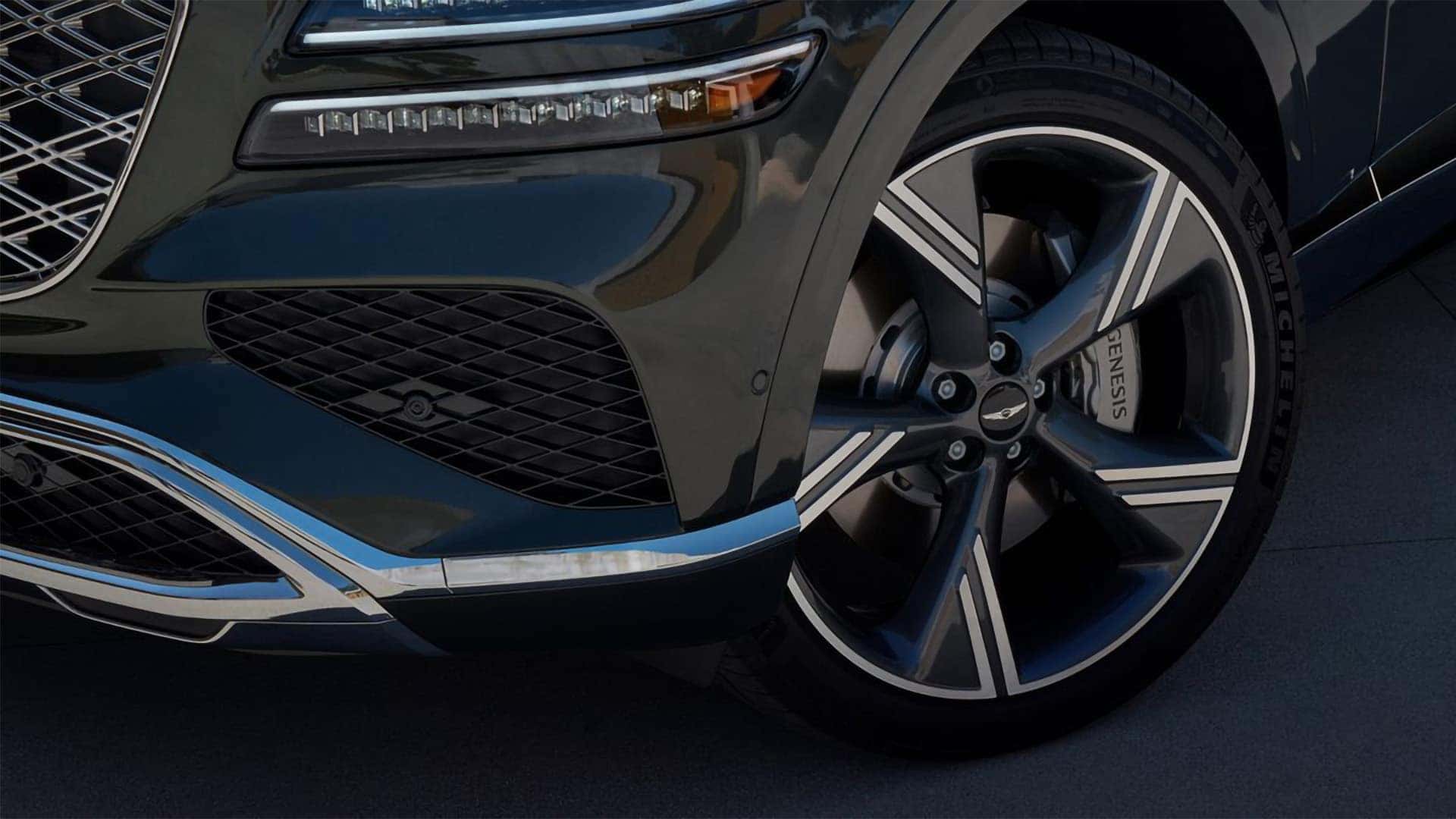 Close up of 2026 Genesis GV80 alloy wheel and front fascia showing premium wheel design and brake detail