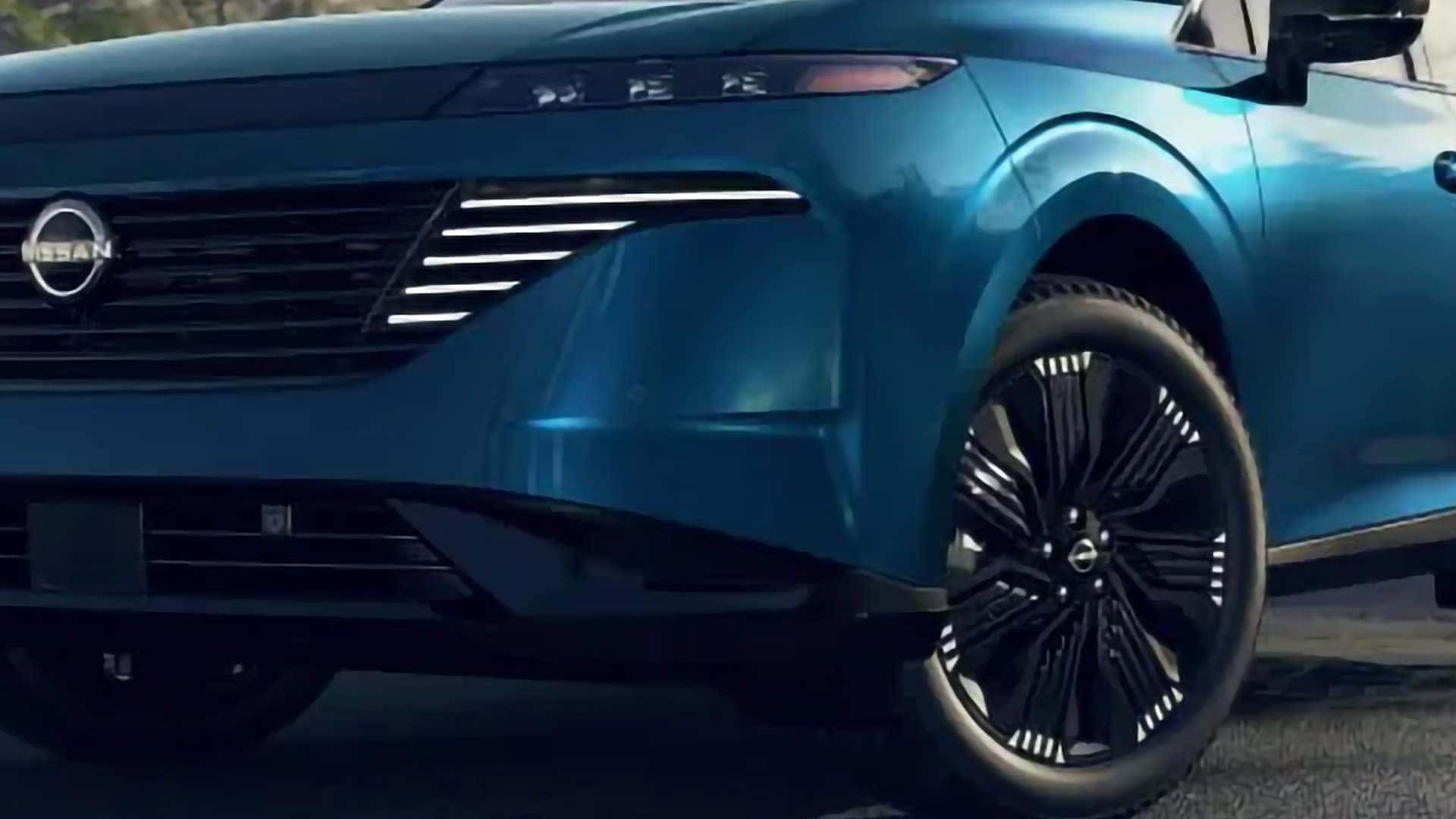 Close up of blue 2026 Nissan Murano front wheel, grille, and LED daytime running lights highlighting premium exterior styling