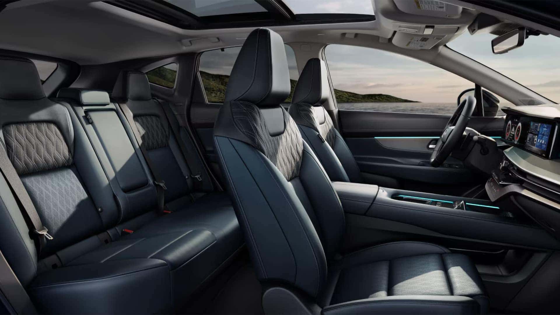 2026 Nissan Murano interior with front and rear seating, panoramic moonroof, and blue ambient cabin lighting