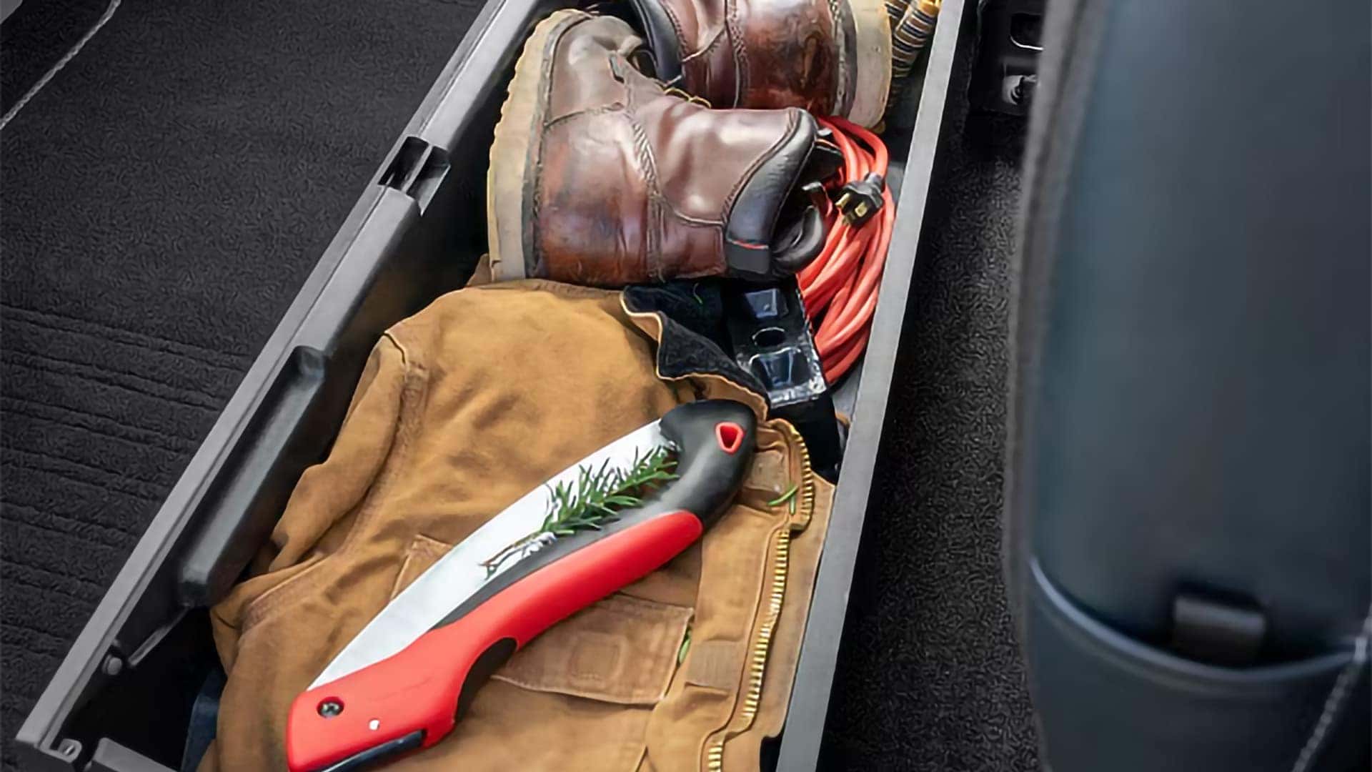 Rear under seat storage compartment in the 2026 Ford F-350 Super Duty holding tools and gear
