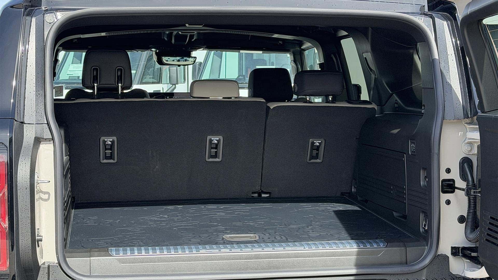 2026 GMC HUMMER EV SUV rear cargo space with flat load floor and split-folding rear seats
