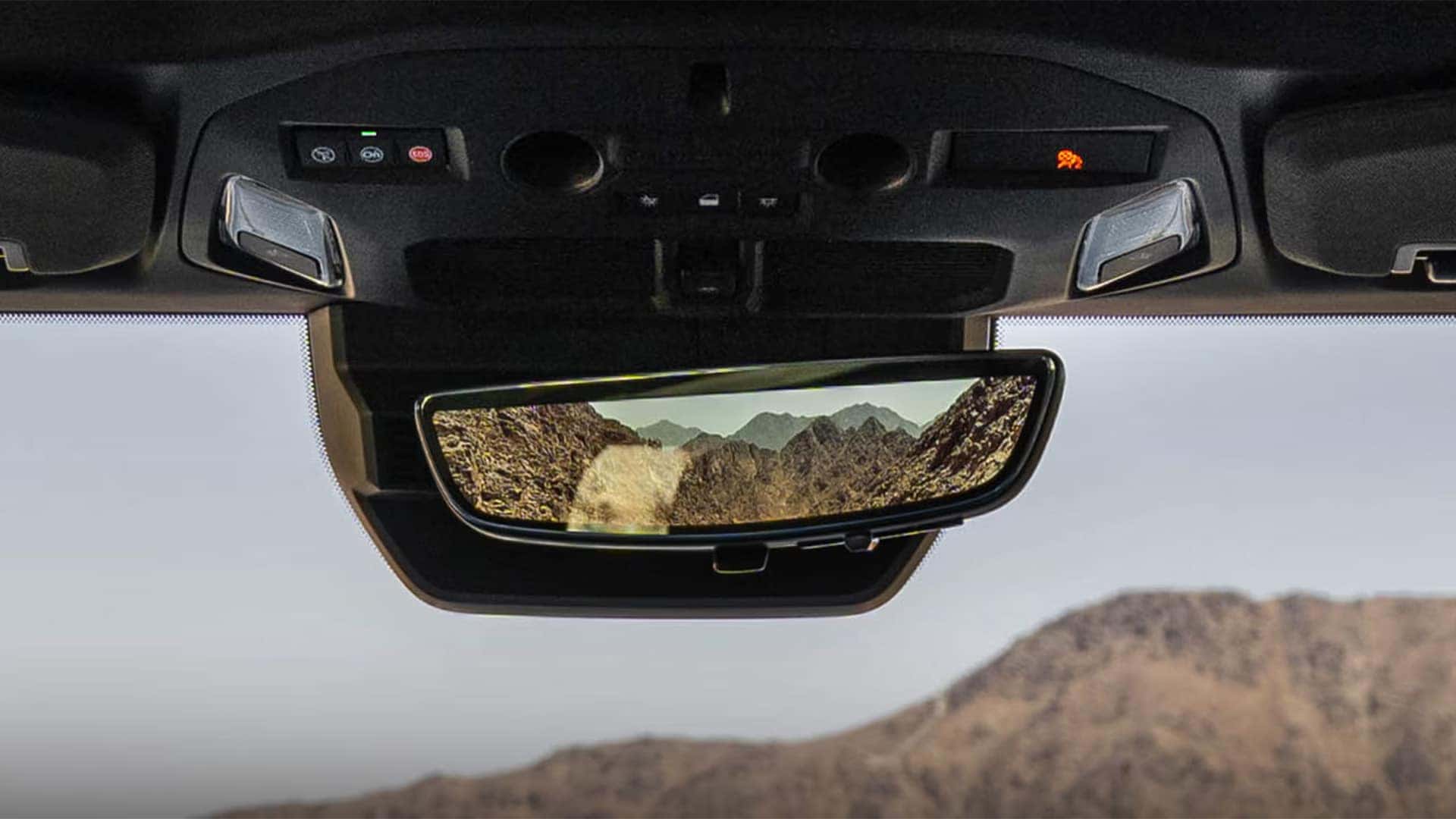 Digital rear camera mirror in the 2026 GMC HUMMER EV SUV displaying a wide rear view for improved visibility while driving