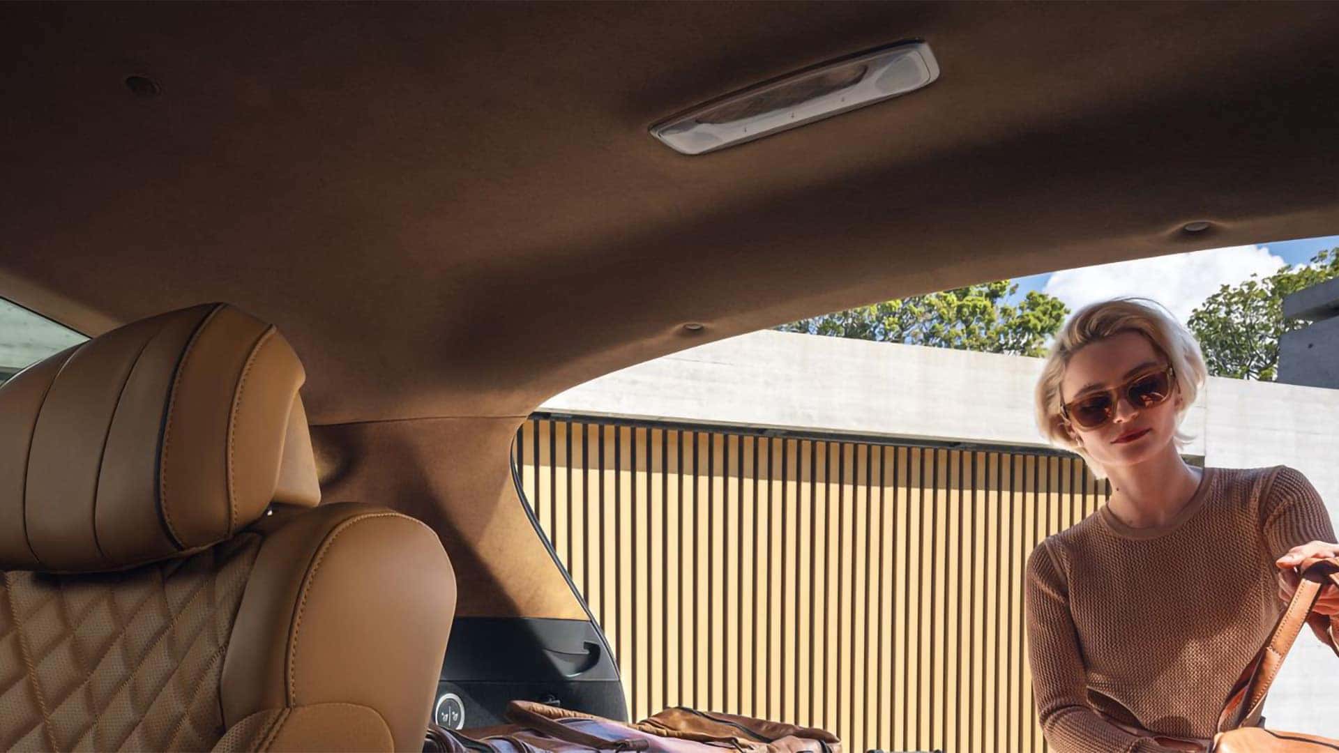 Rear cargo area of the 2026 Genesis GV80 with seats folded and spacious interior storage area