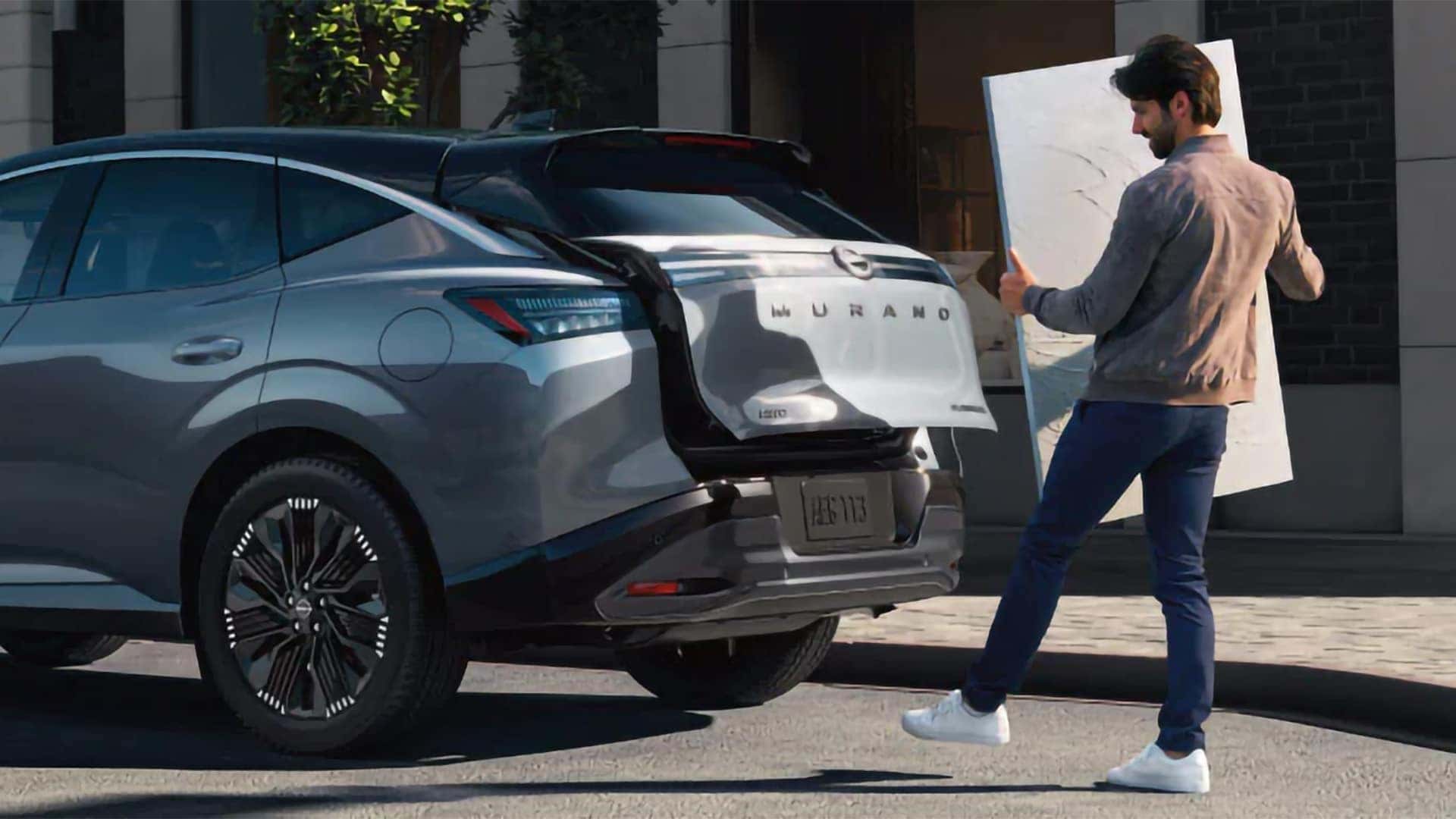 Rear view of 2026 Nissan Murano with motion activated liftgate open for cargo loading outside modern home