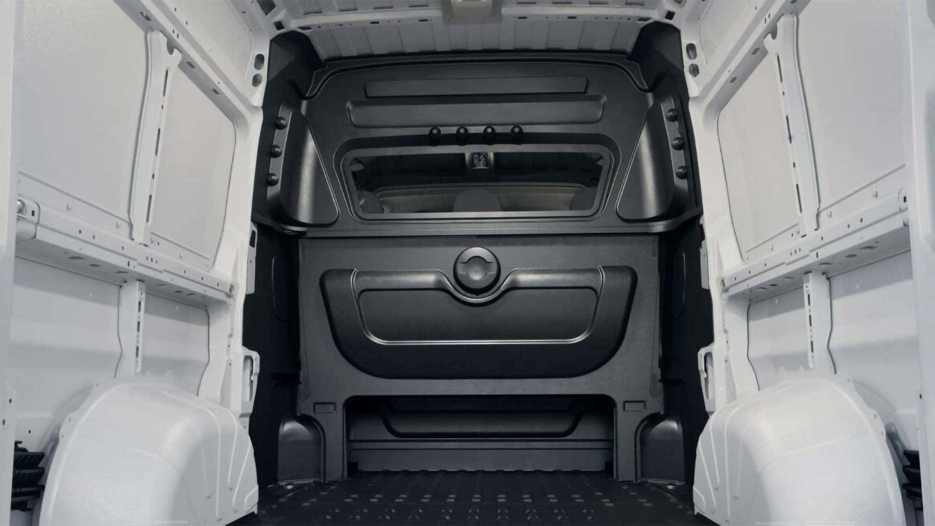 2026 RAM ProMaster Cargo Van cargo area with partition wall and open load floor for commercial storage