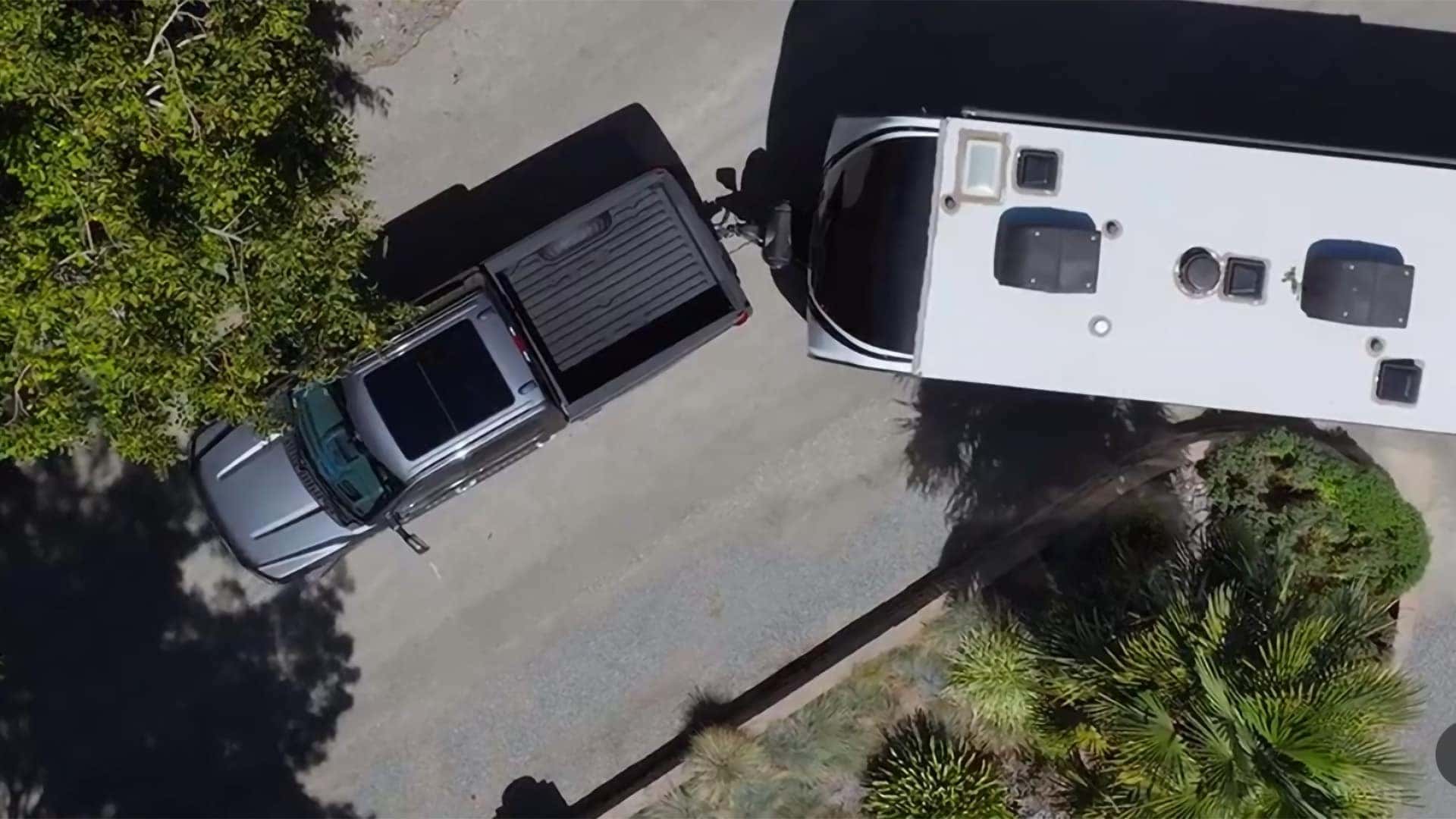 2026 Ford F-350 Super Duty towing a travel trailer with an overhead view showing trailer alignment