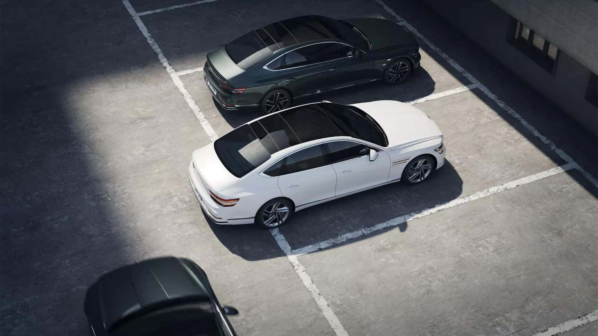 2026 Genesis G80 parked in a lot from above, demonstrating driver assistance and parking technology