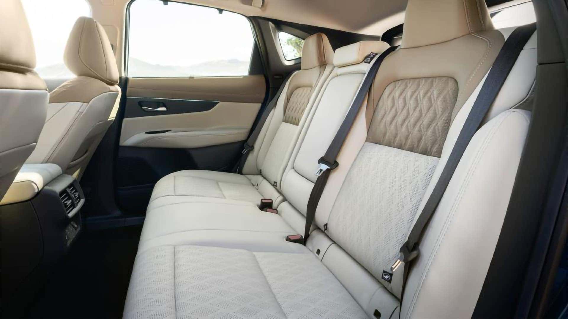 2026 Nissan Murano rear seats with light upholstery, patterned inserts, and roomy second-row passenger space