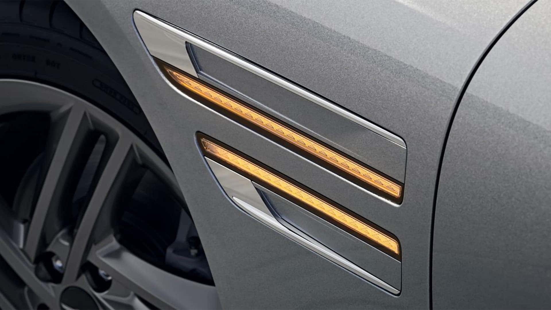 Close up of 2026 Genesis G80 side marker and trim detail with illuminated accent lighting and body panel design