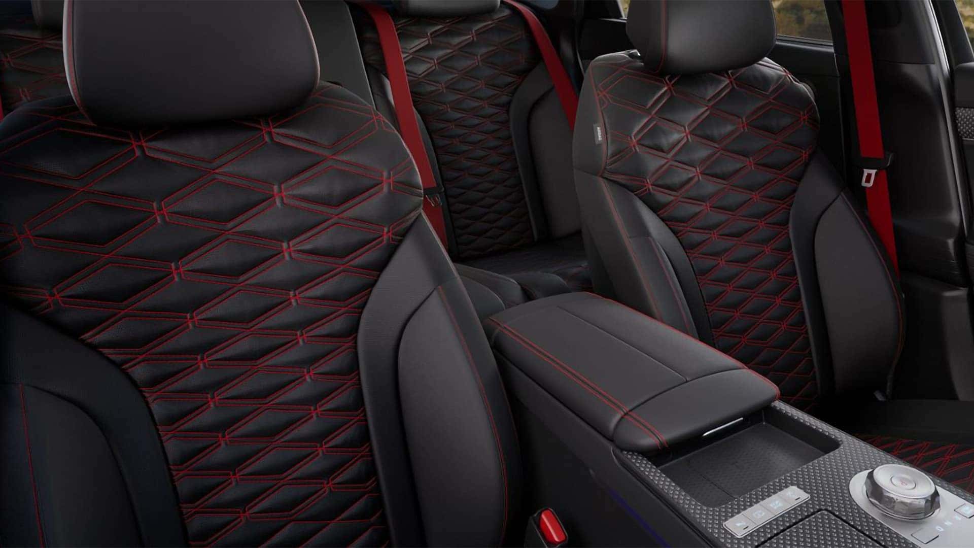 2026 Genesis G80 front seats with sport-inspired quilting, red stitching, and illuminated interior accents