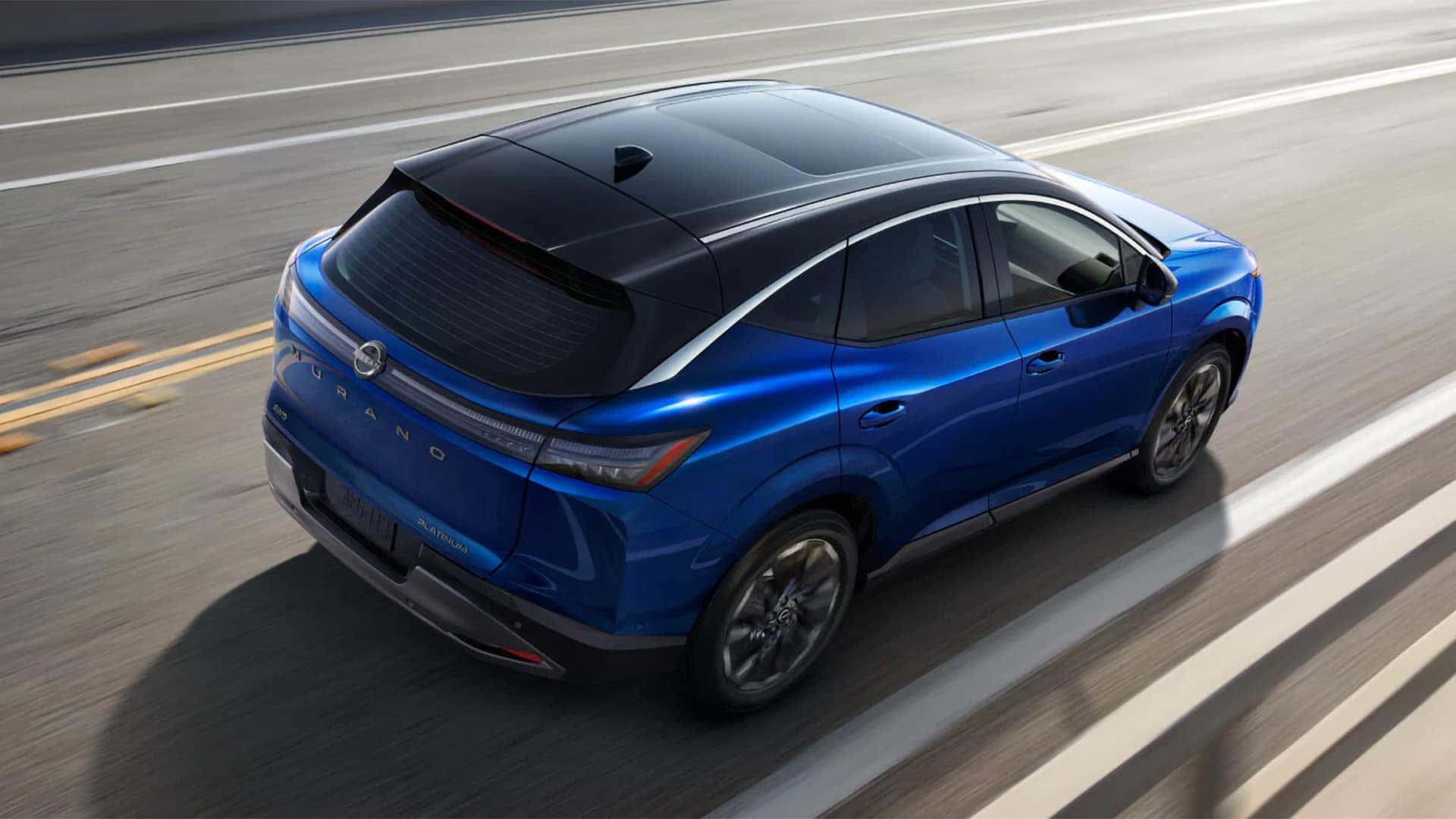 Blue 2026 Nissan Murano from above showing two tone black roof, panoramic moonroof, and rear exterior design
