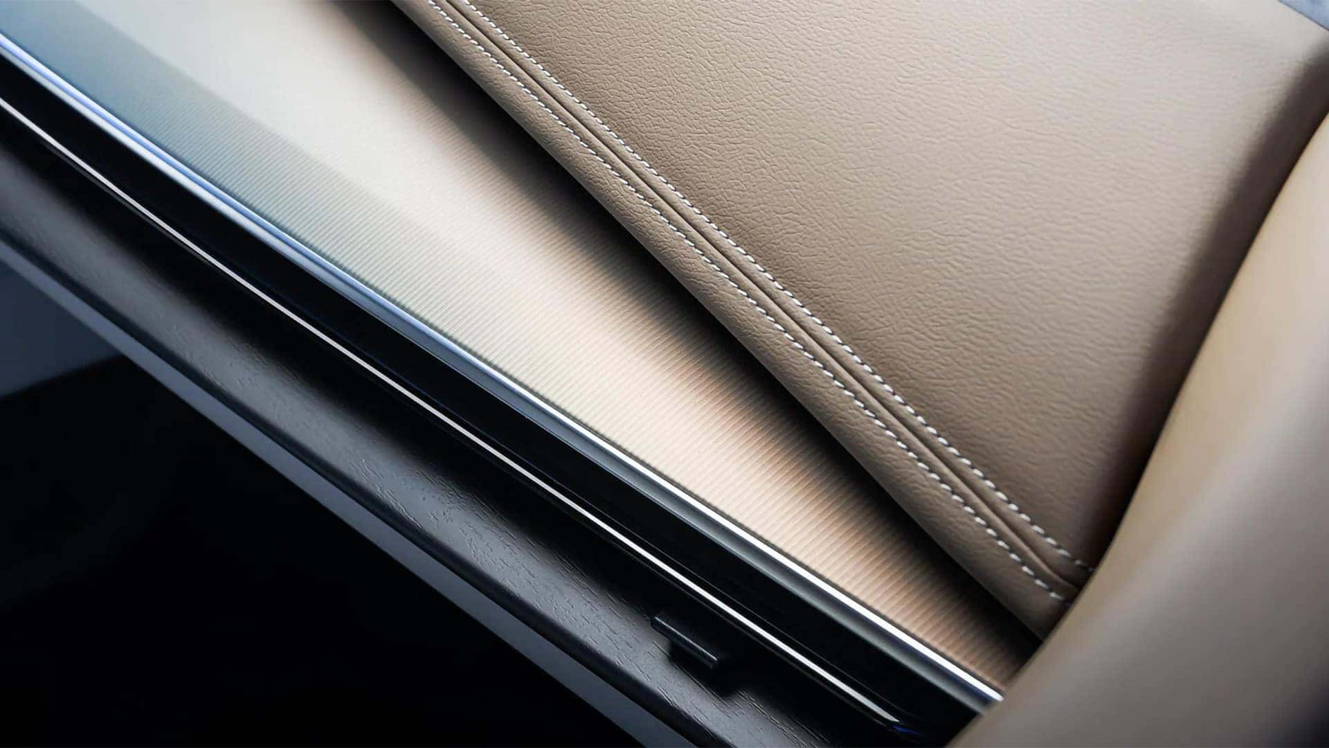 Close-up of 2026 Nissan Murano interior materials with stitched soft-touch trim and textured dash finish