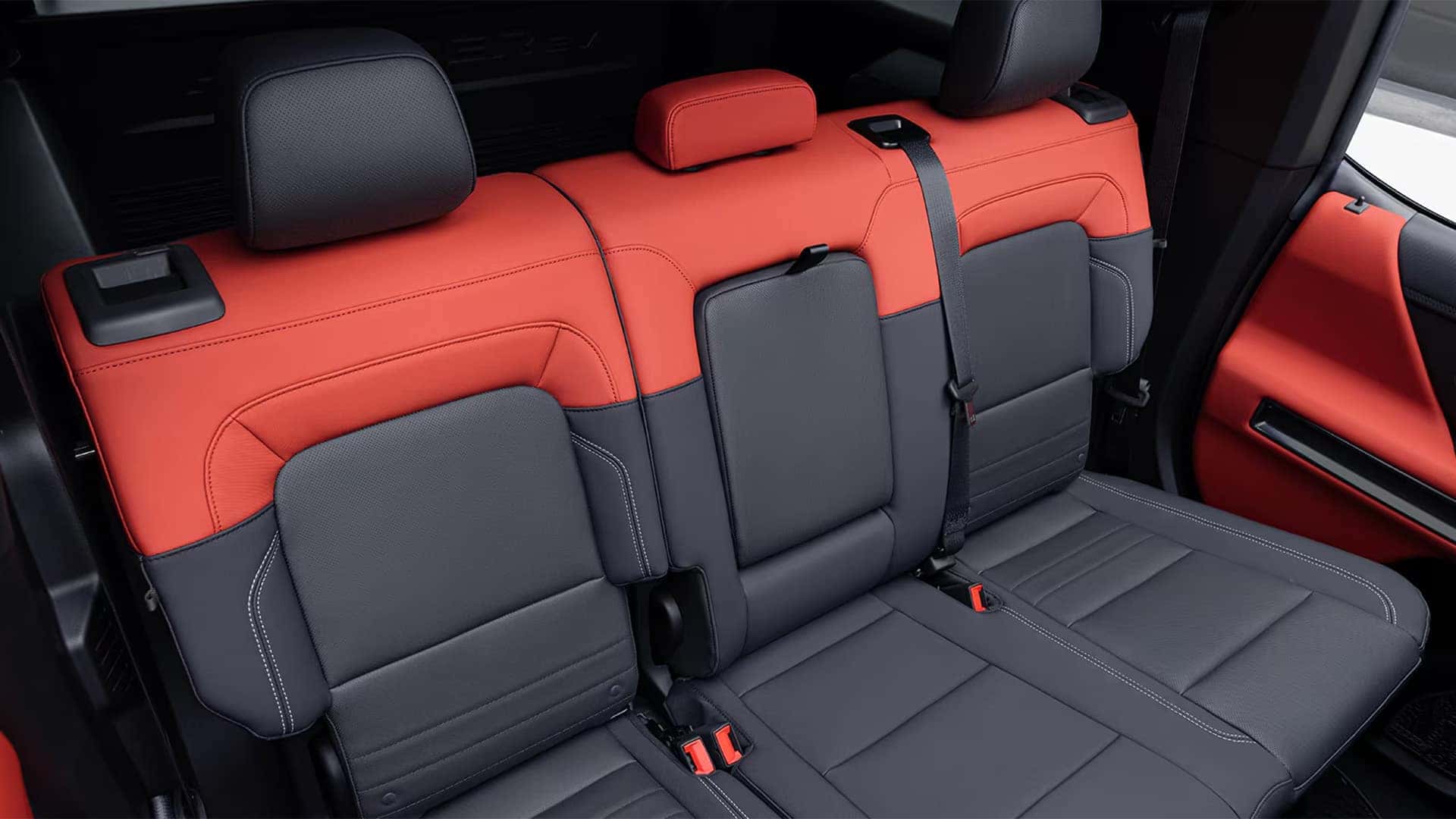 2026 GMC HUMMER EV SUV rear seating area with two-tone upholstery and spacious second-row bench