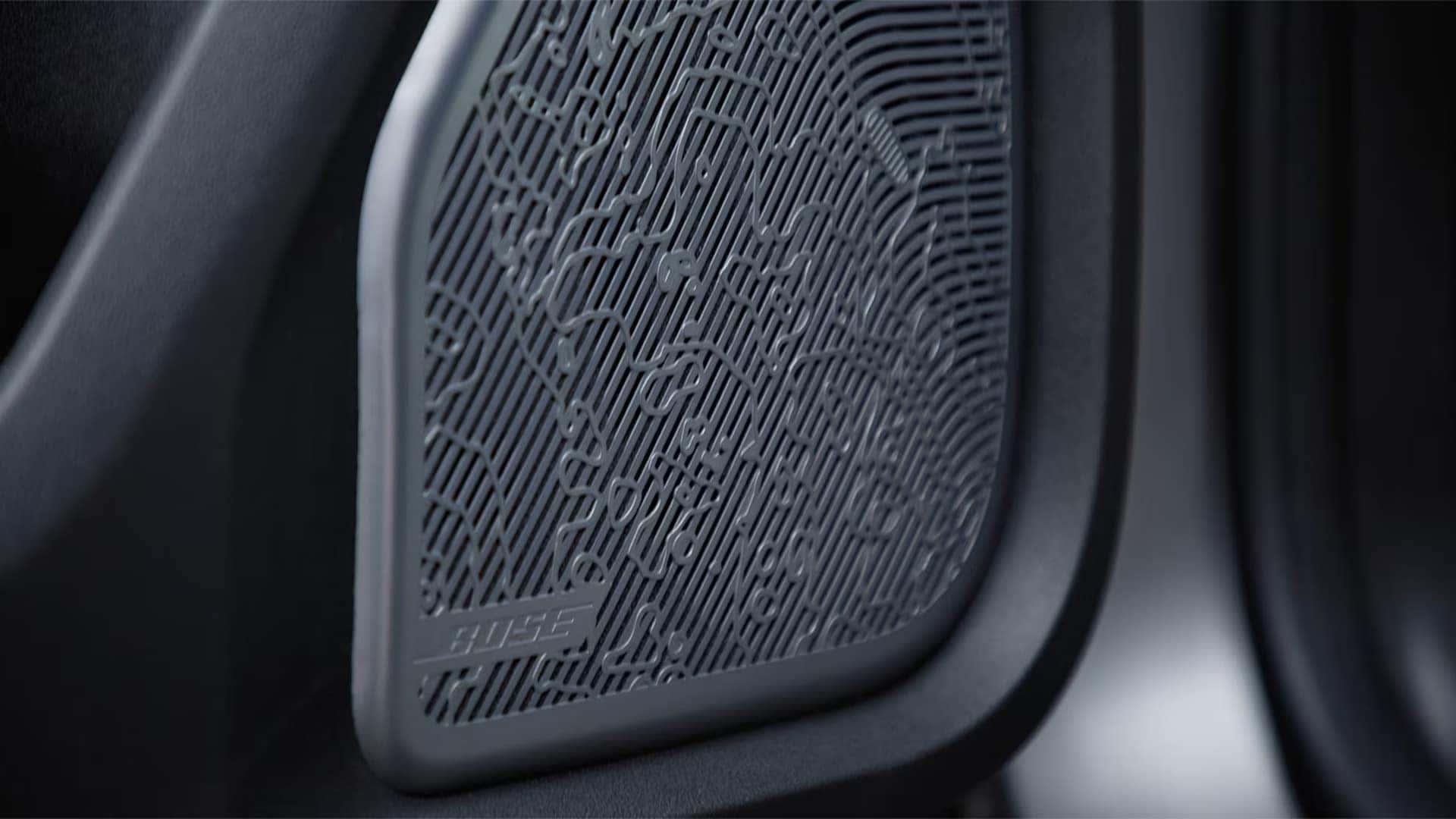 Close-up of Bose speaker grille inside the 2026 GMC HUMMER EV SUV showing premium audio system detail