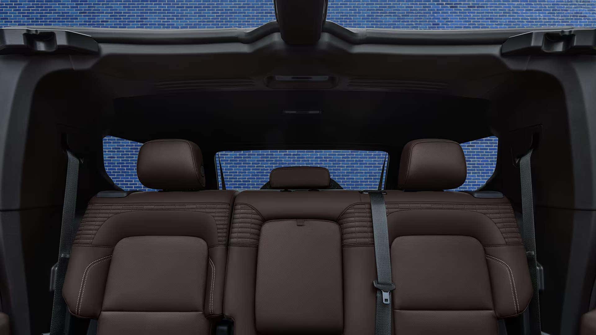 2026 GMC HUMMER EV SUV interior rear view showing headrests, wide cabin space, and roof structure
