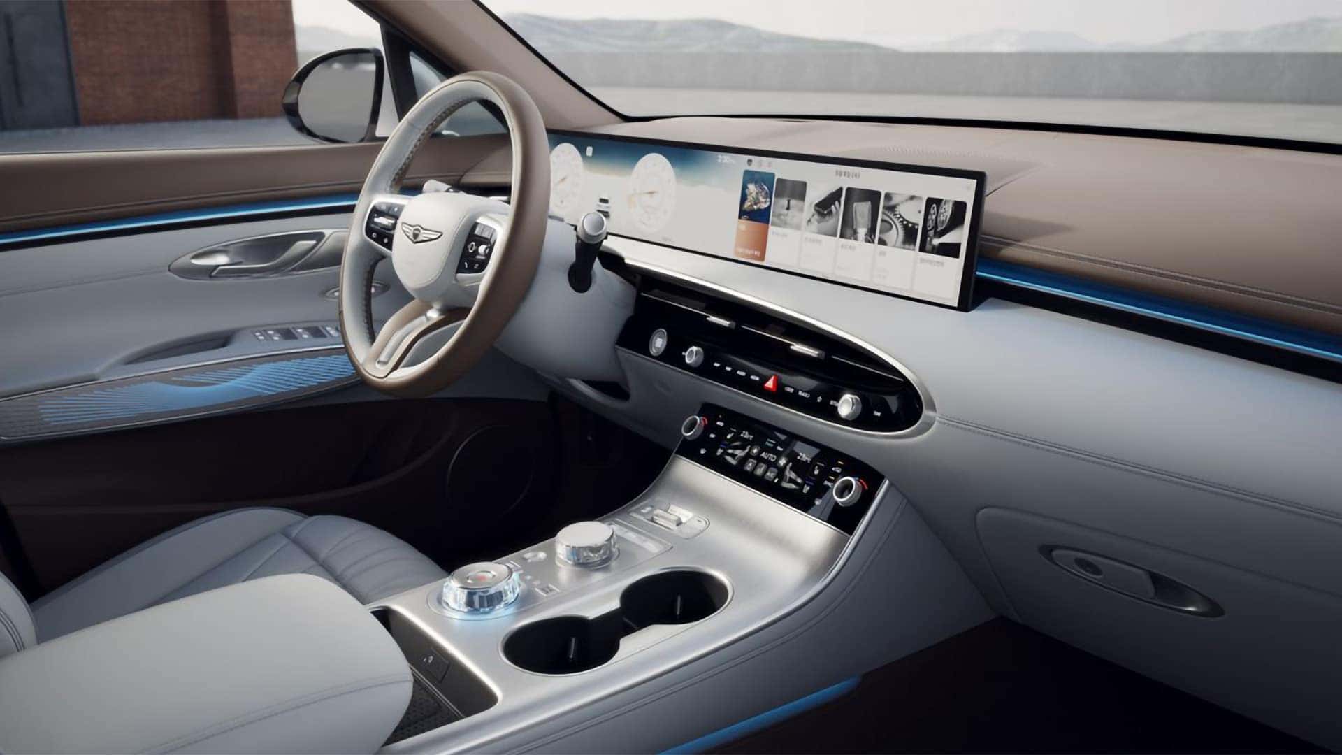 2026 Genesis GV70 interior with wide OLED display, ambient lighting, center console controls, and premium dashboard design