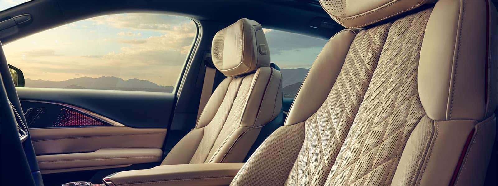 2026 Cadillac LYRIQ interior with premium quilted front seats, ambient door lighting, and a spacious luxury EV cabin