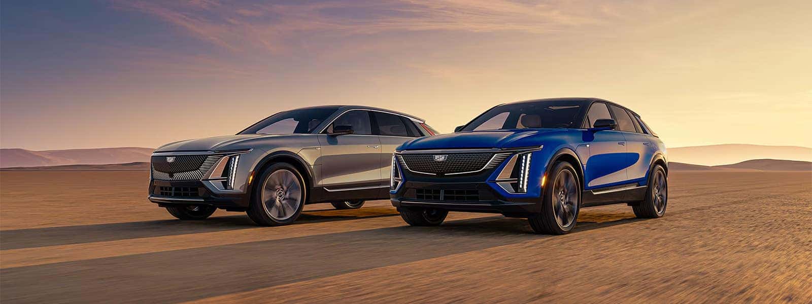 2026 Cadillac LYRIQ electric SUVs driving across a desert landscape at sunset