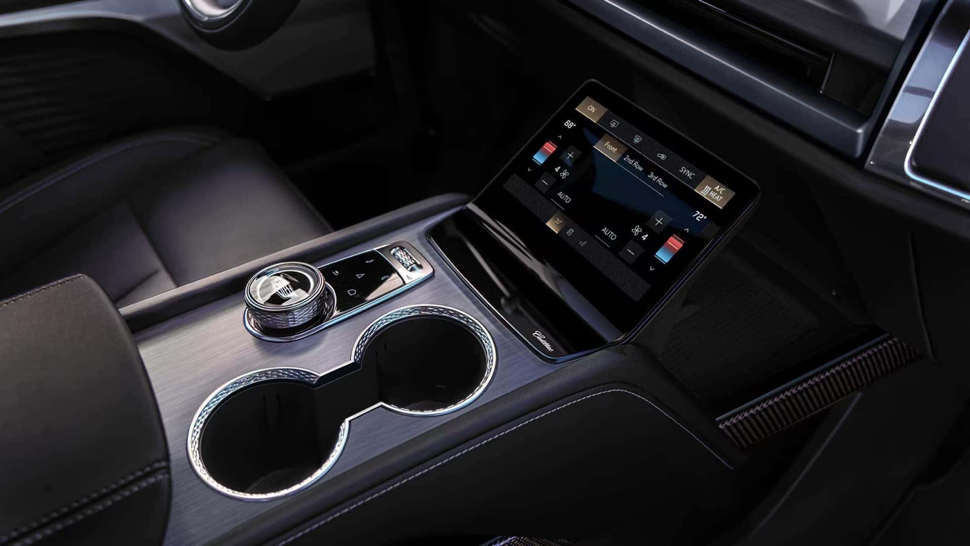 2026 Cadillac VISTIQ center console with command center touchscreen, rotary controller, and cupholders