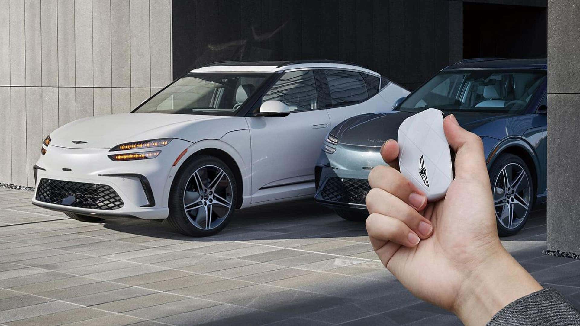 Genesis GV60 key fob used near two 2026 Genesis GV60 electric SUVs with smart access technology