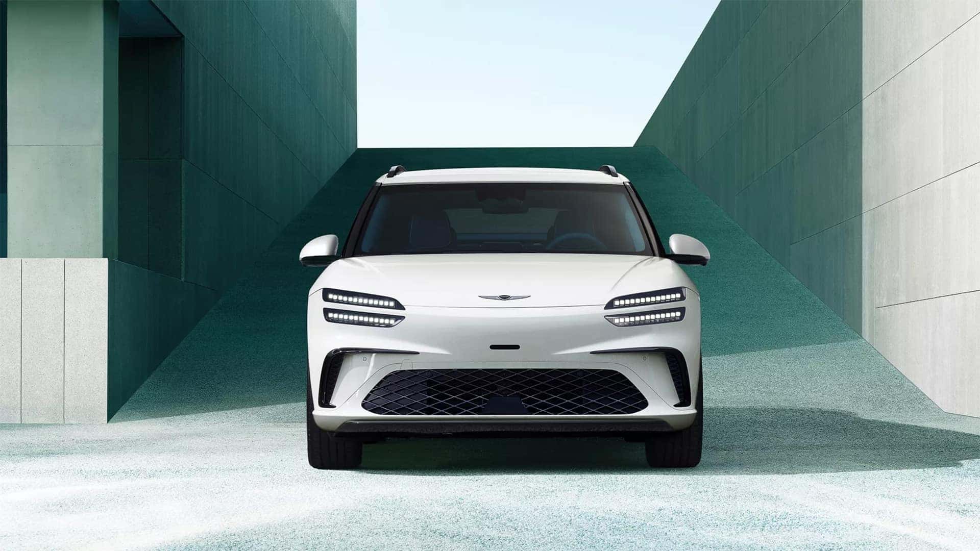 2026 Genesis GV60 front exterior view showing Two-Line LED headlights and sculpted electric SUV styling