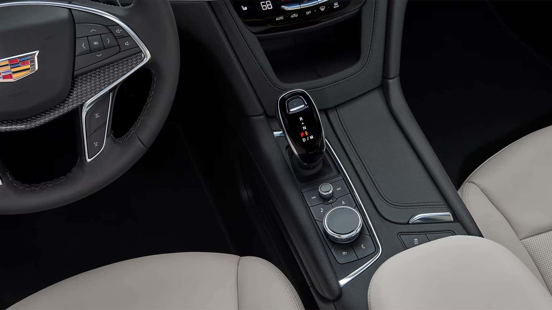 Cadillac XT5 center console with gear selector, steering wheel controls, climate settings, and premium interior trim