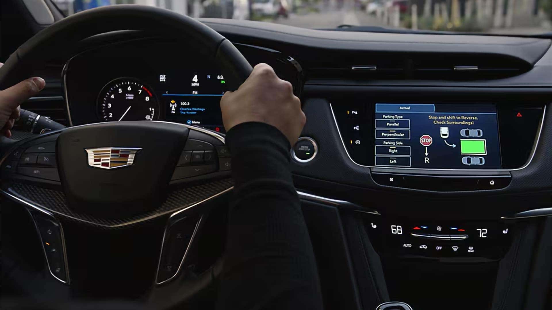 2026 Cadillac XT5 driver cockpit showing infotainment screen with parking assist controls and digital driver display