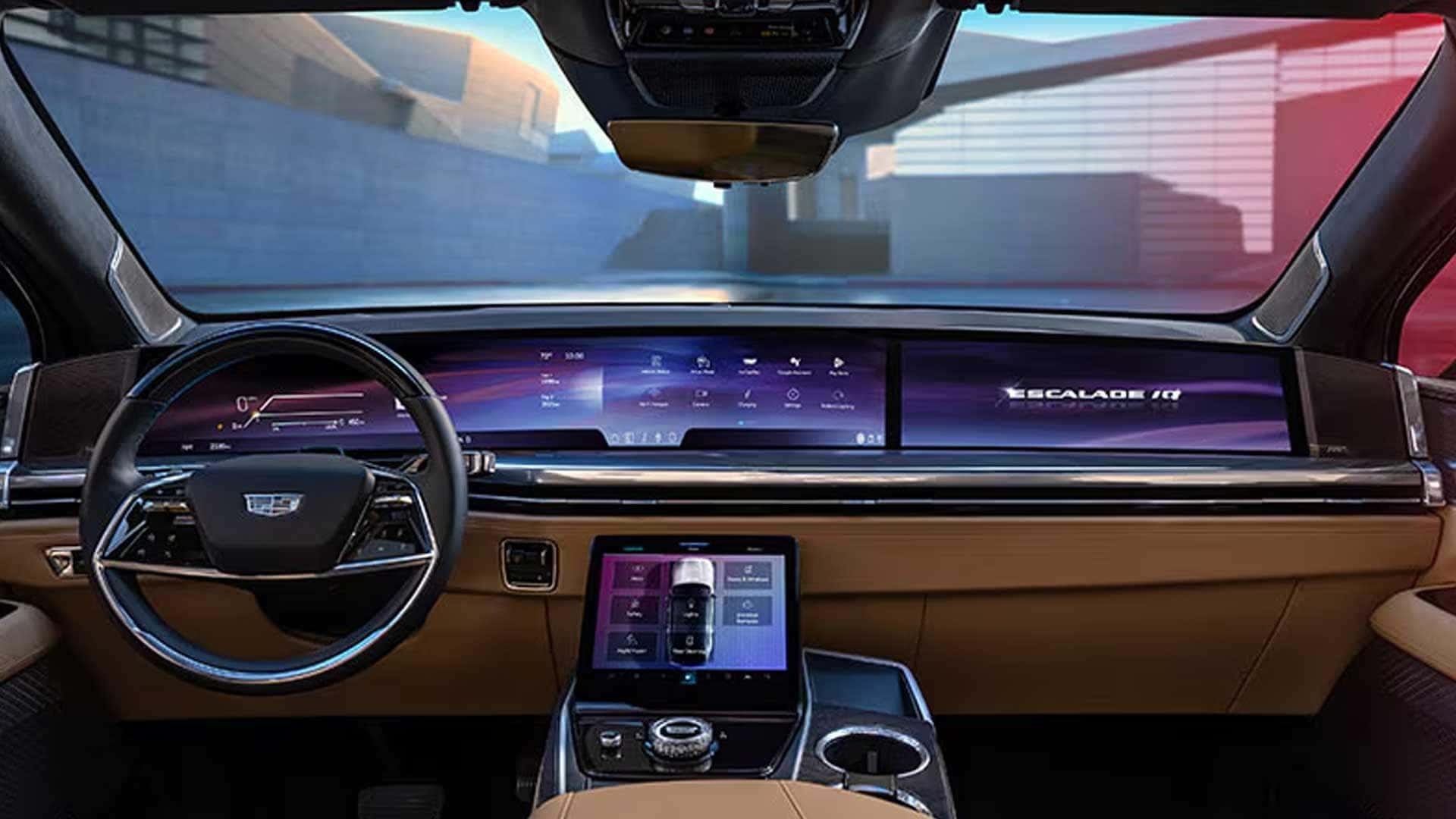 Front cabin with steering wheel, wide digital display across dashboard, and center touchscreen controls
