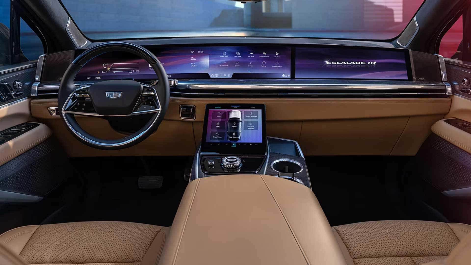 Front cabin with steering wheel, wide dashboard display, center touchscreen, tan trim, and front seats