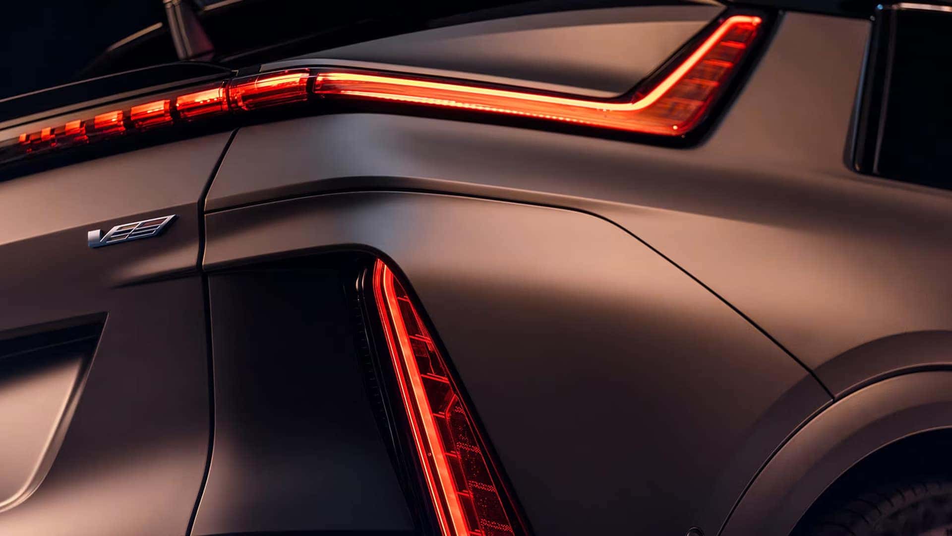 Close up of the 2026 Cadillac LYRIQ rear LED taillights and V-Series badge on the sculpted liftgate area