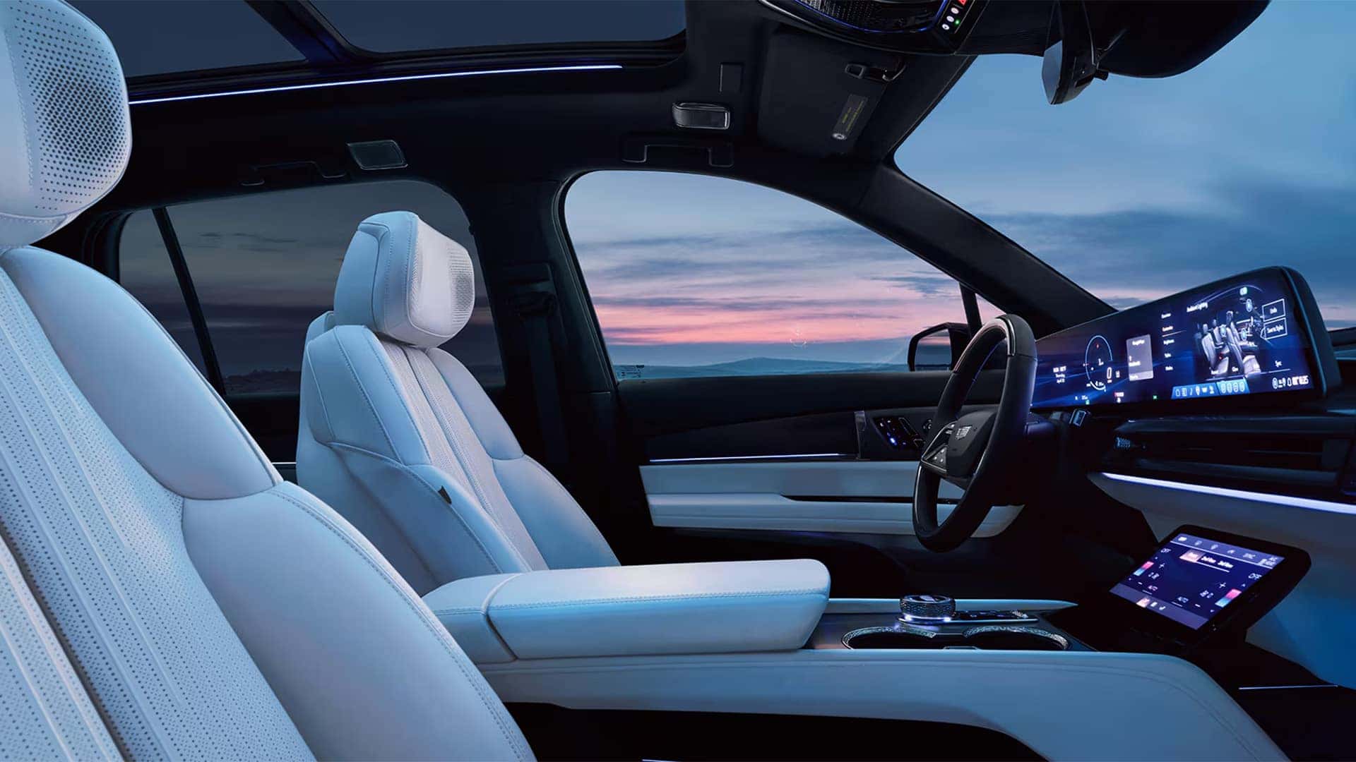 2026 Cadillac VISTIQ front cabin with white seats, panoramic glass roof, ambient lighting, and curved digital display