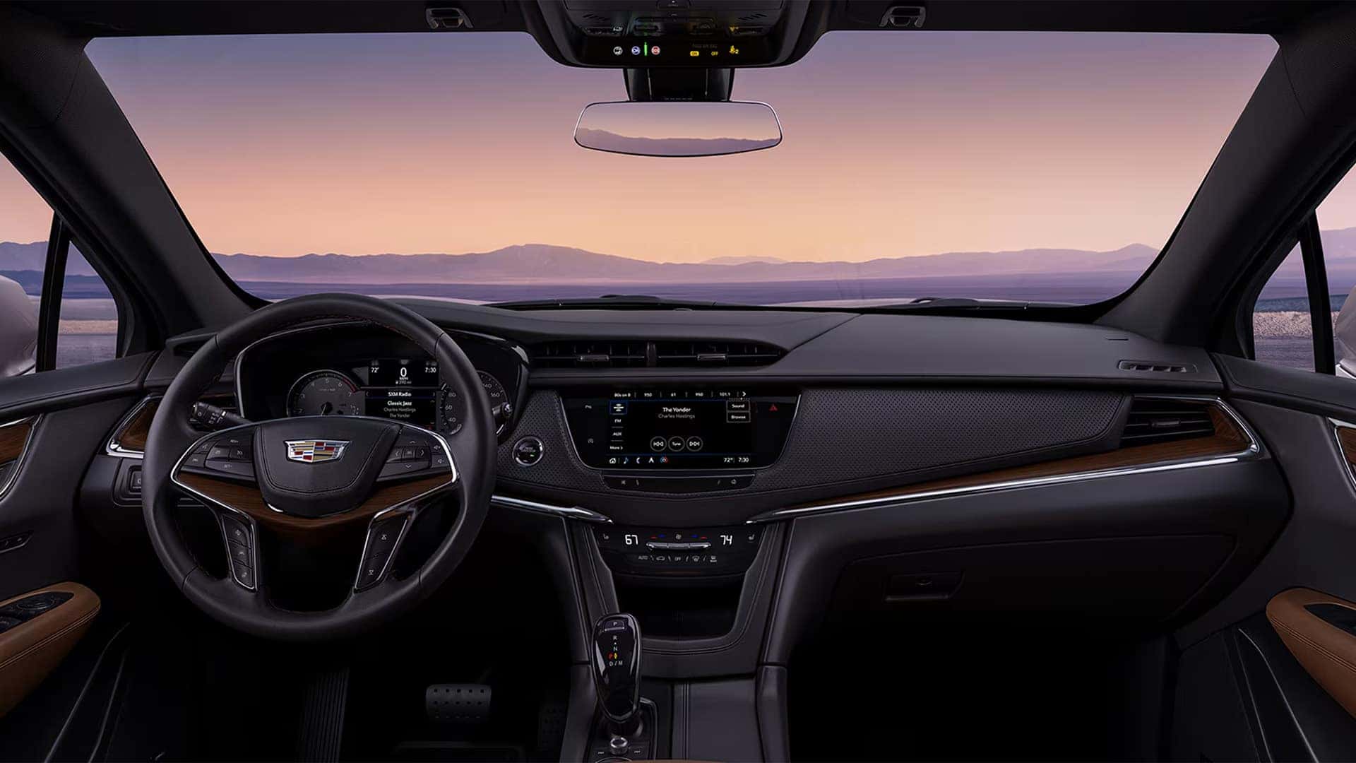 2026 Cadillac XT5 dashboard with infotainment display, driver controls, steering wheel, and panoramic windshield view