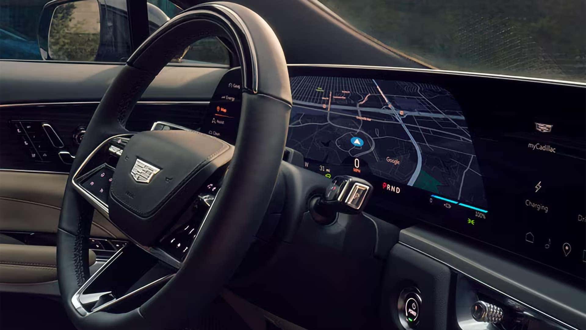 2026 Cadillac LYRIQ dashboard with 33-inch curved display, Google navigation, steering wheel controls, and digital EV interface