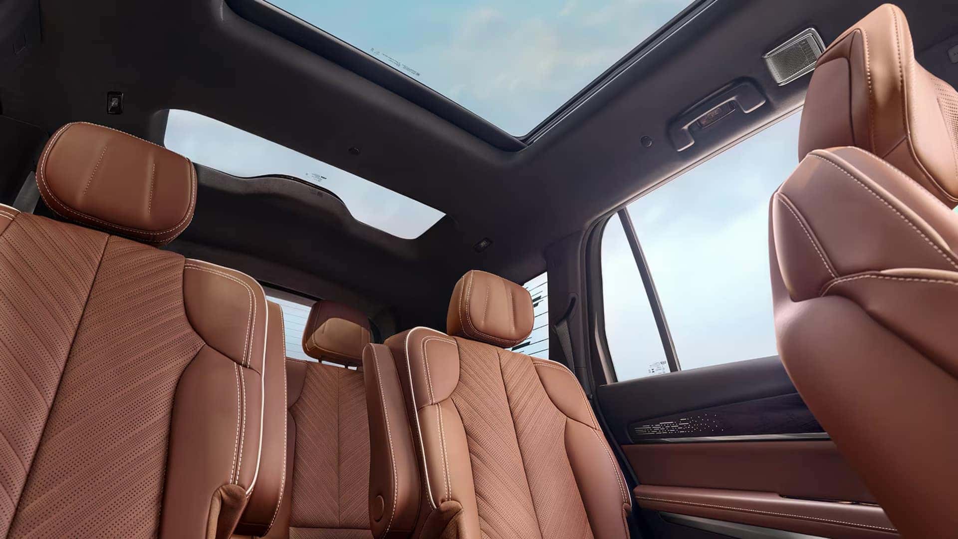 2026 Cadillac VISTIQ three-row interior with brown leather seating, second-row captain’s chairs, and panoramic glass roof