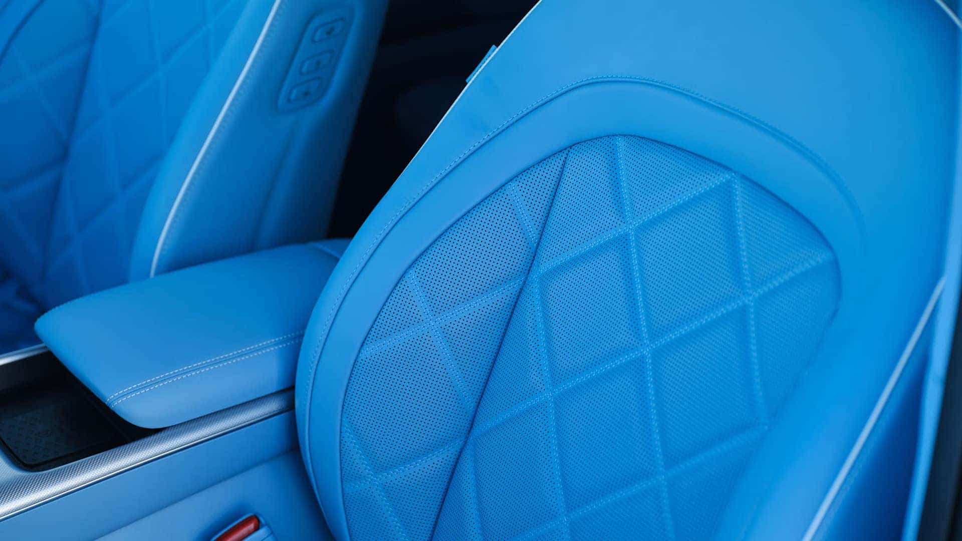 2026 Genesis GV60 blue quilted front seats with perforated upholstery and premium interior stitching