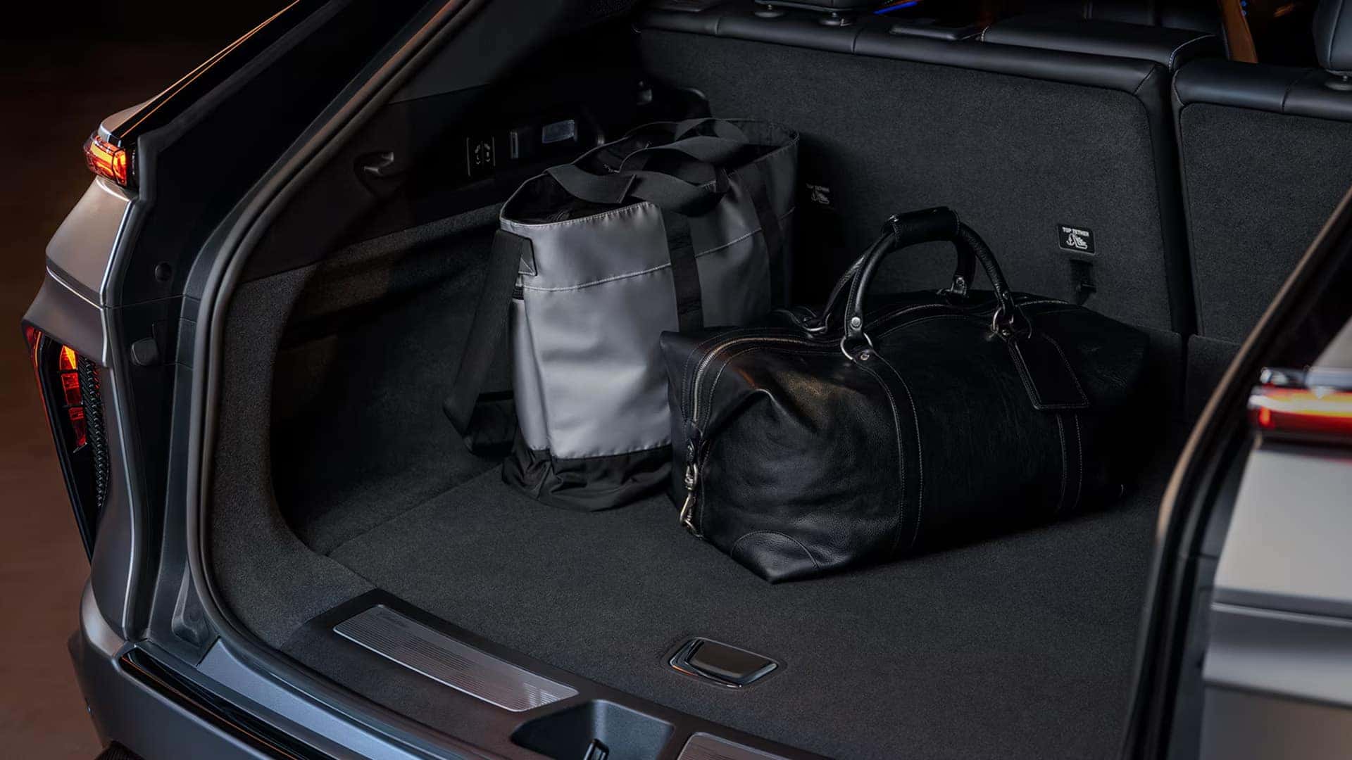 2026 Cadillac LYRIQ cargo area with rear storage space and luggage in the electric luxury SUV