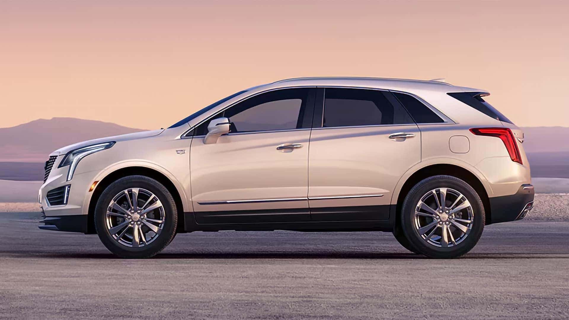 White 2026 Cadillac XT5 side profile showing midsize luxury SUV proportions, roofline, wheels, and body design