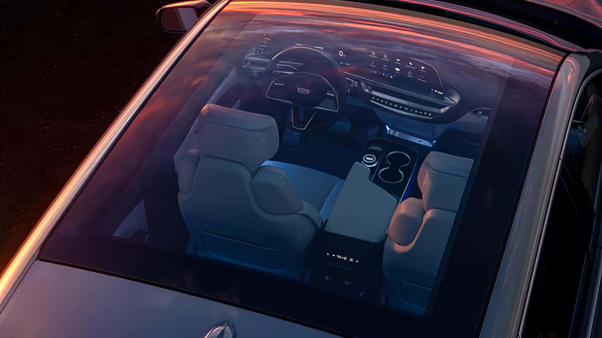 Overhead view through the 2026 Cadillac LYRIQ glass roof showing the front cabin, steering wheel, and digital display