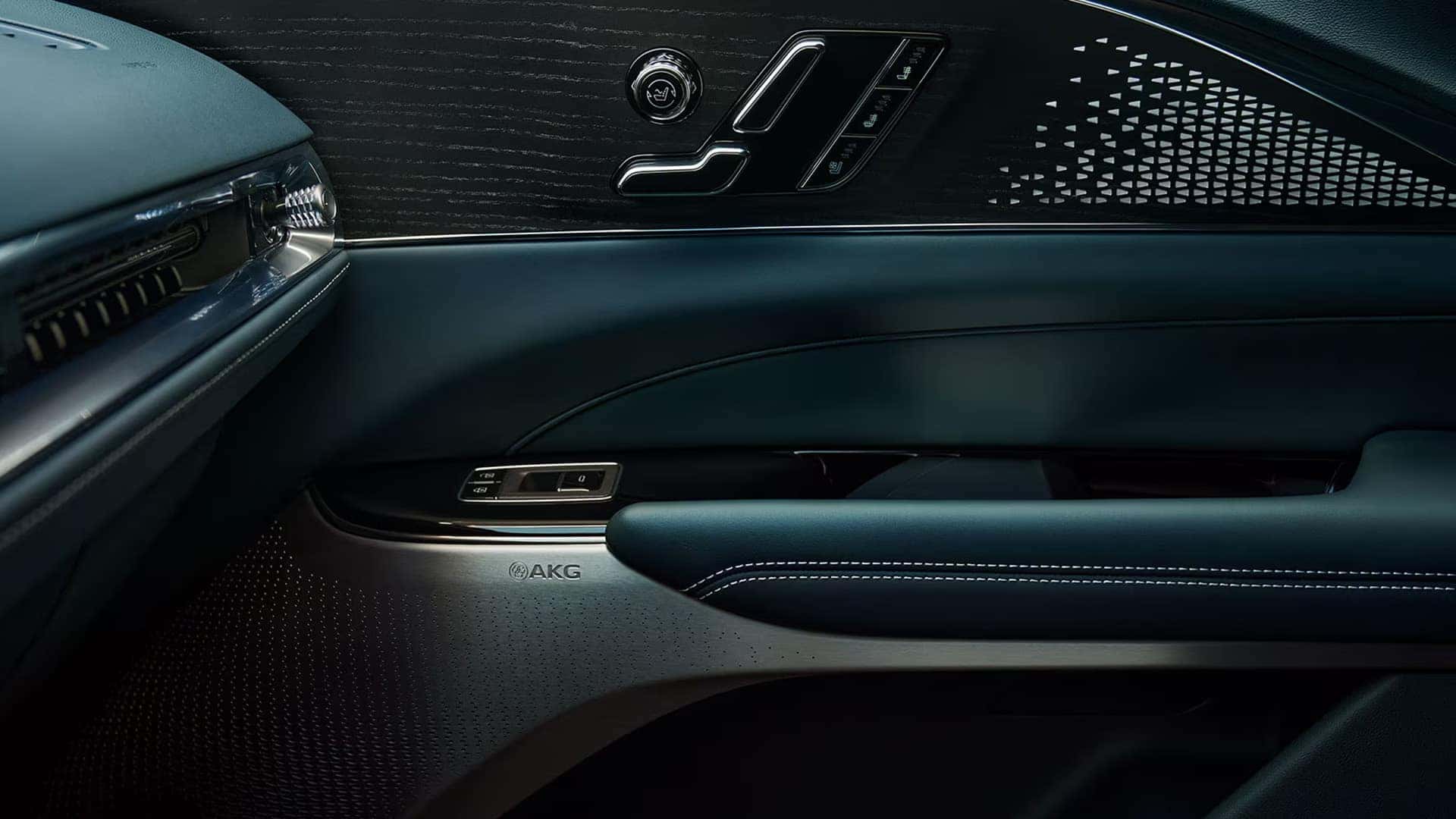 2026 Cadillac LYRIQ interior door panel with AKG audio speaker, seat controls, and premium trim details