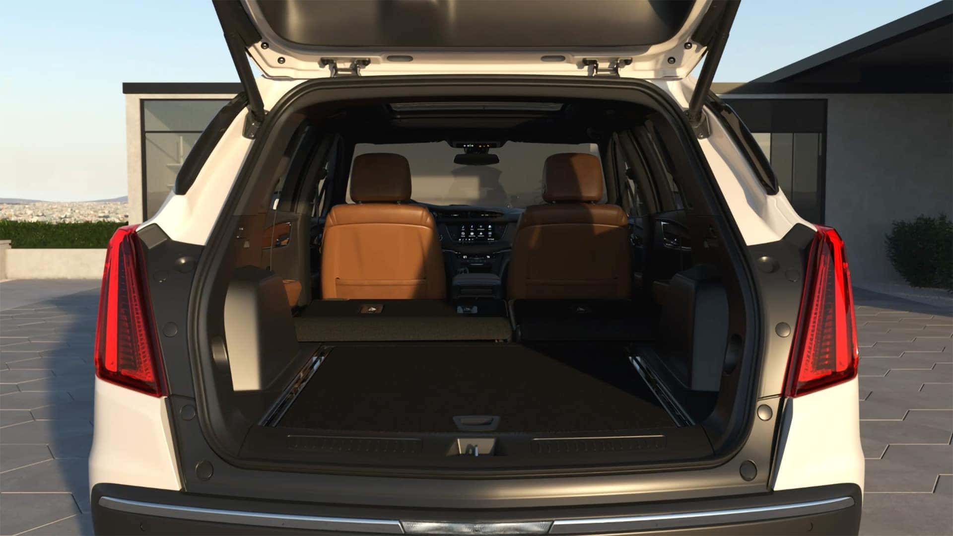 Rear cargo area of 2026 Cadillac XT5 with liftgate open showing interior cargo space and vertical taillamps