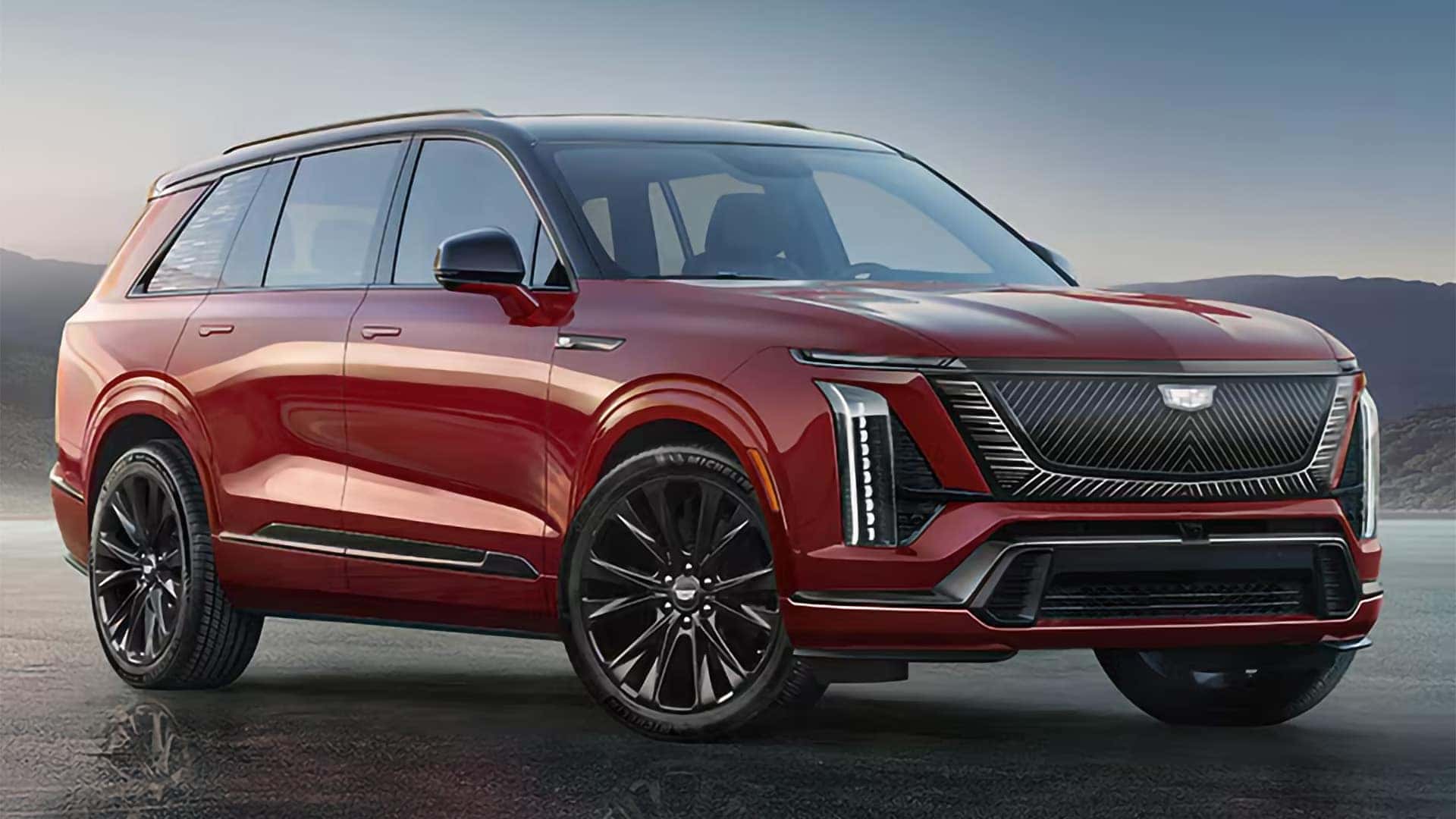 Red 2026 Cadillac VISTIQ shown from the front driver side with black wheels, black roof, vertical LED lighting, and bold grille design