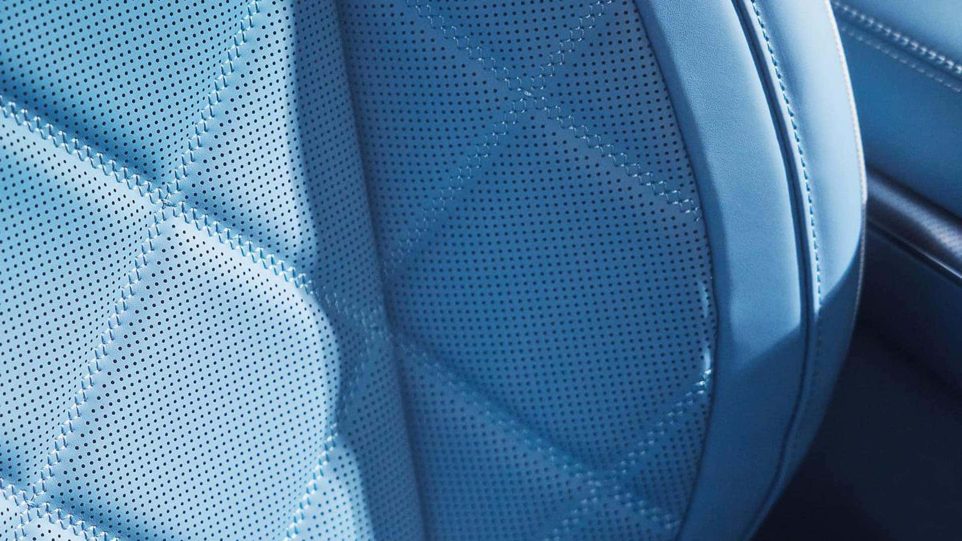 2026 Genesis GV60 blue perforated quilted seat upholstery showing premium interior materials and stitching detail