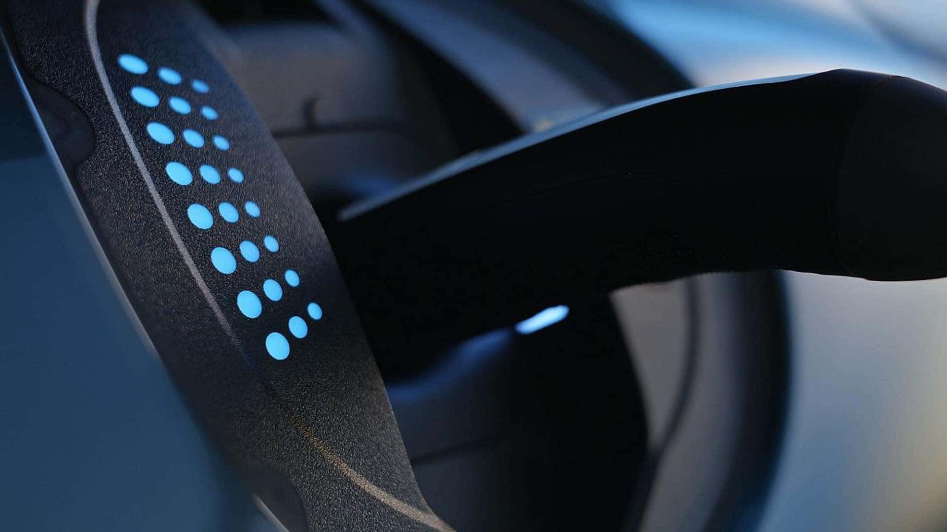 Close-up of 2026 Genesis GV60 charging port with illuminated EV charging indicator lights