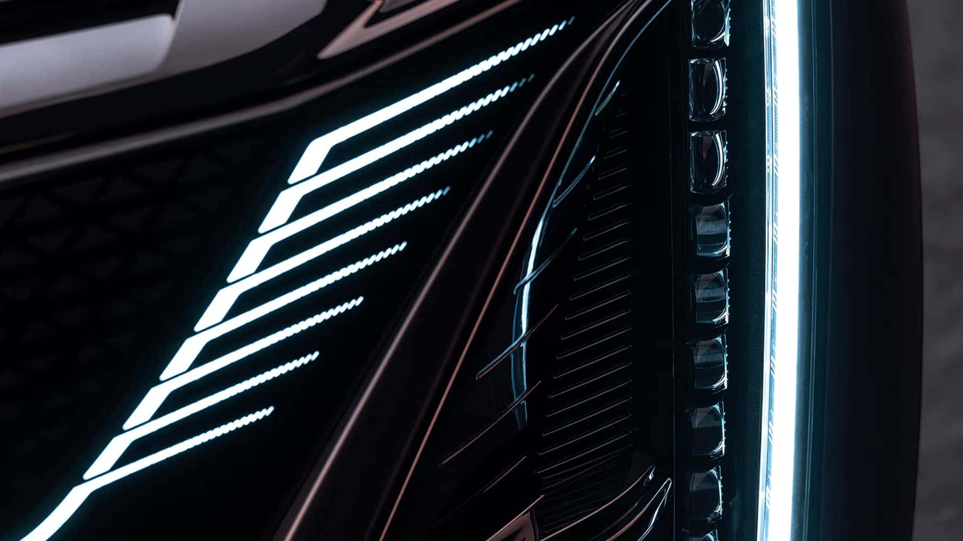 Close up of the 2026 Cadillac LYRIQ illuminated grille and vertical LED front lighting signature