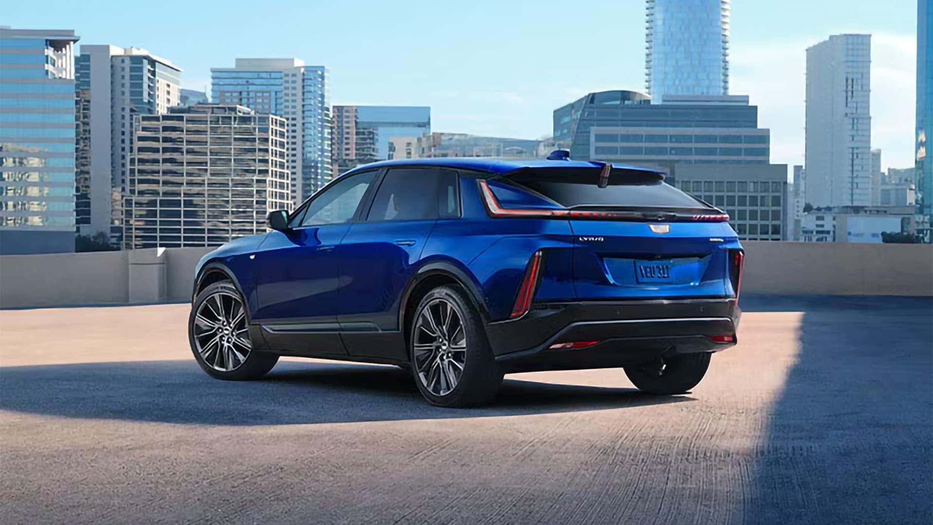 Blue 2026 Cadillac LYRIQ rear three-quarter view showing taillights, roofline, wheels, and electric SUV cargo area profile