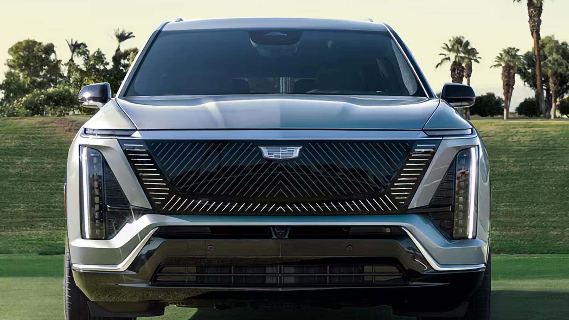 Front view of the 2026 Cadillac VISTIQ showing vertical LED lights, illuminated grille pattern, and Cadillac EV design