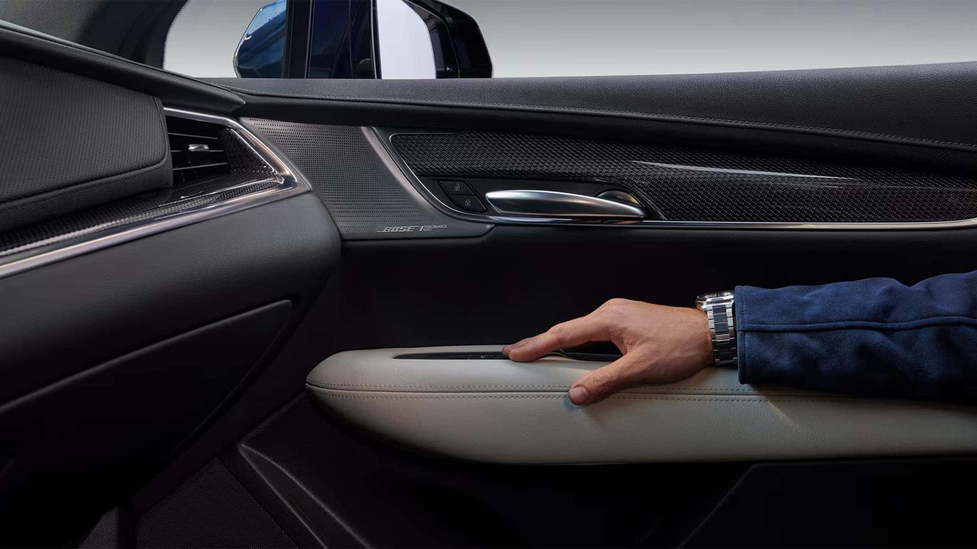 2026 Cadillac XT5 interior door trim with Bose speaker, metallic accents, and premium cabin materials