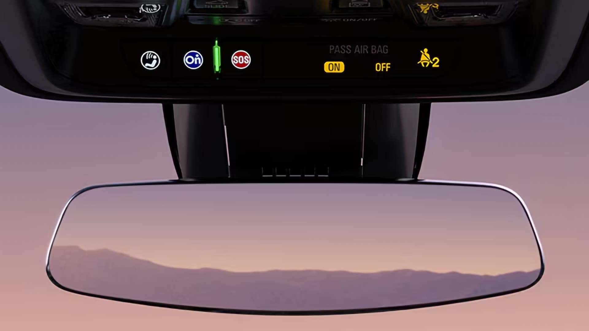 2026 Cadillac XT5 rearview mirror area with OnStar, SOS, and camera-related controls above the windshield